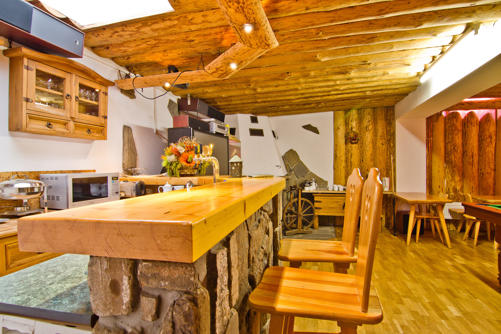 Billiards room with wooden bar and shared kitchen