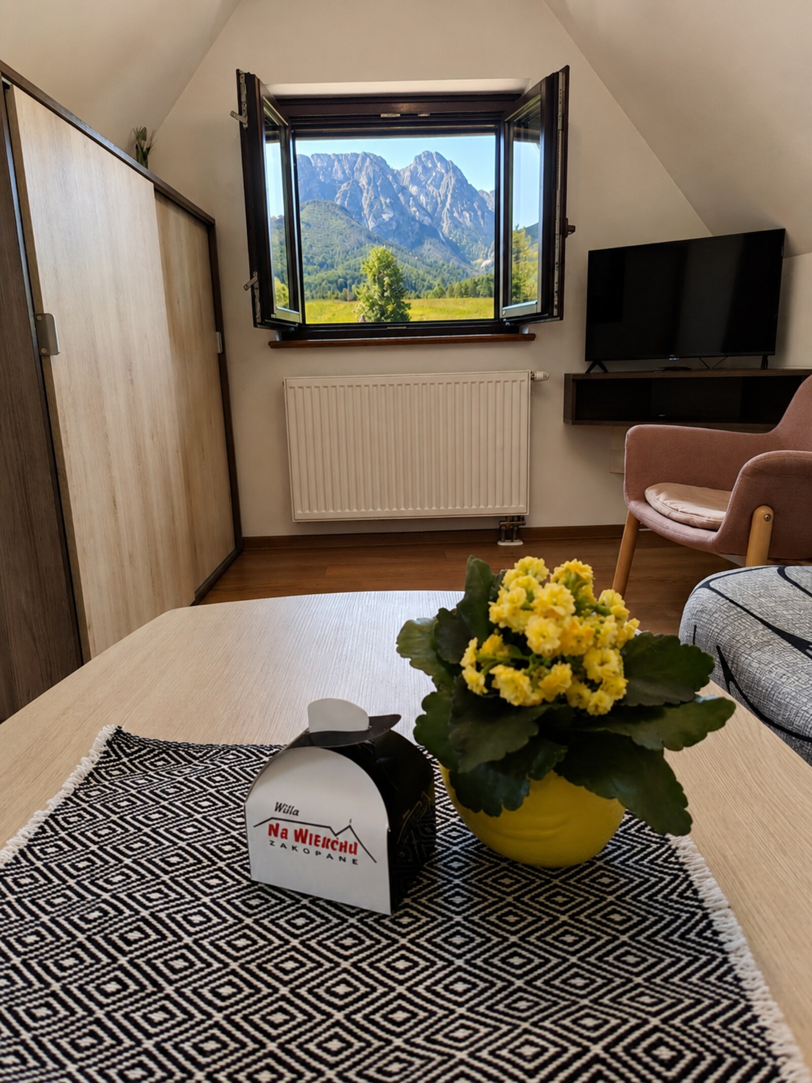 Attic apartment interior with Giewont view from window
