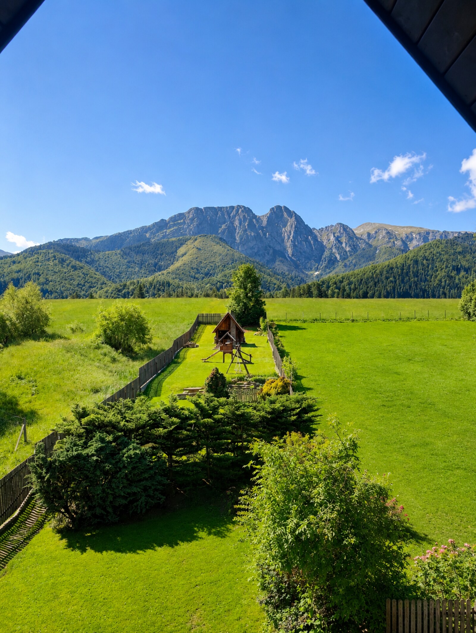 Garden view with playhouse and Giewont in the background